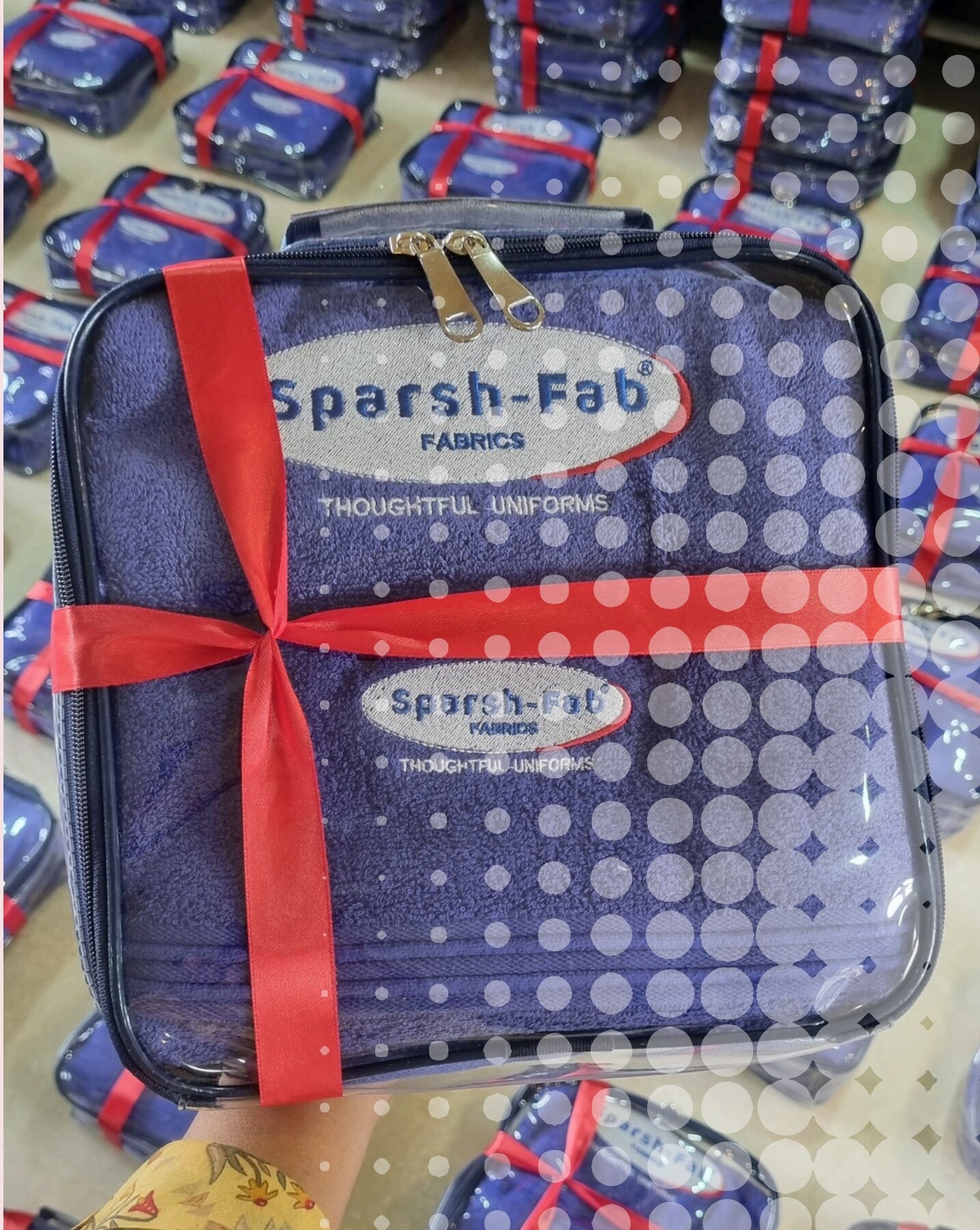 Blue zippered bag with branded towel and napkin set tied with ribbon