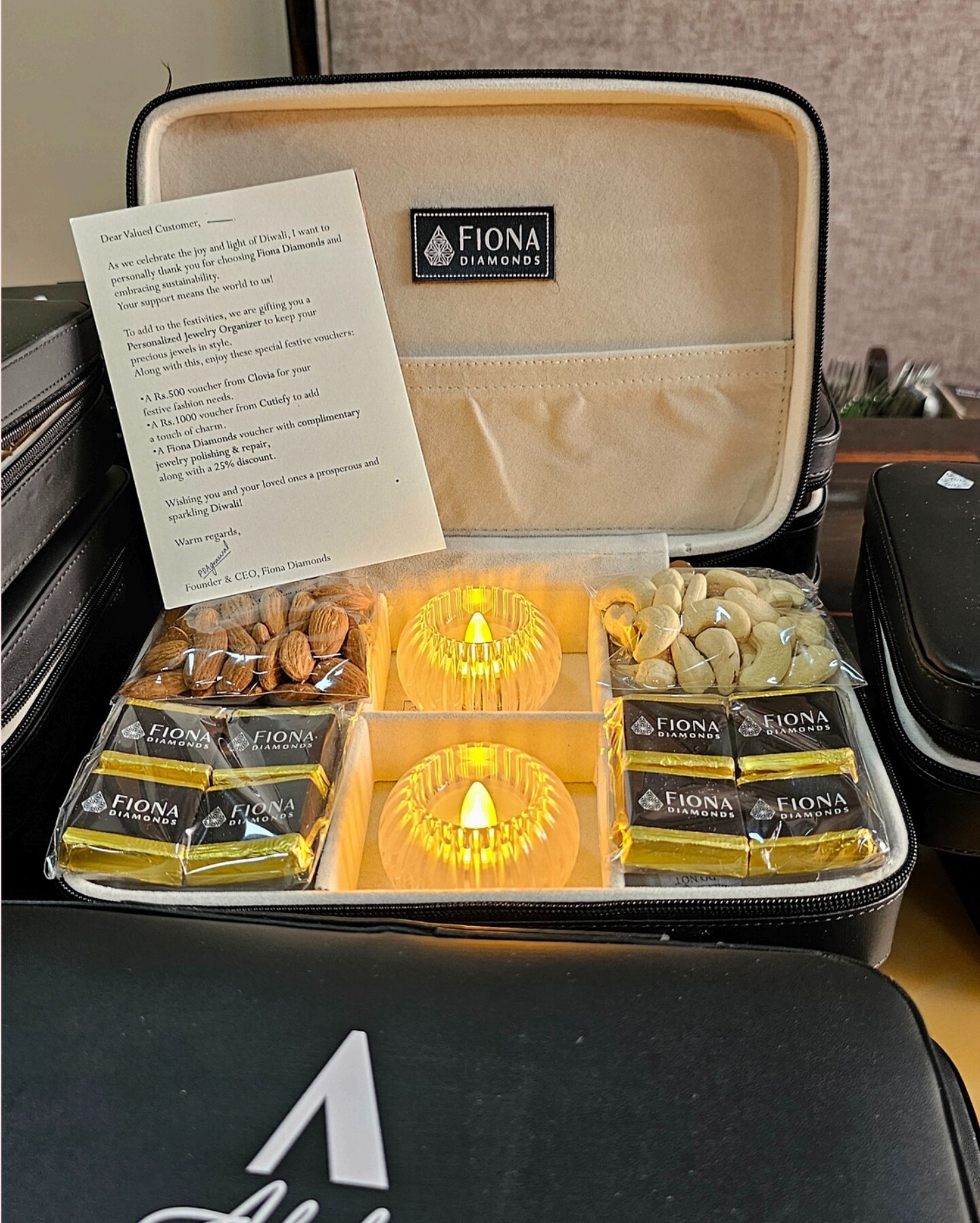 Festive Diwali gift box with dry fruits, mithai, diyas, and greeting card